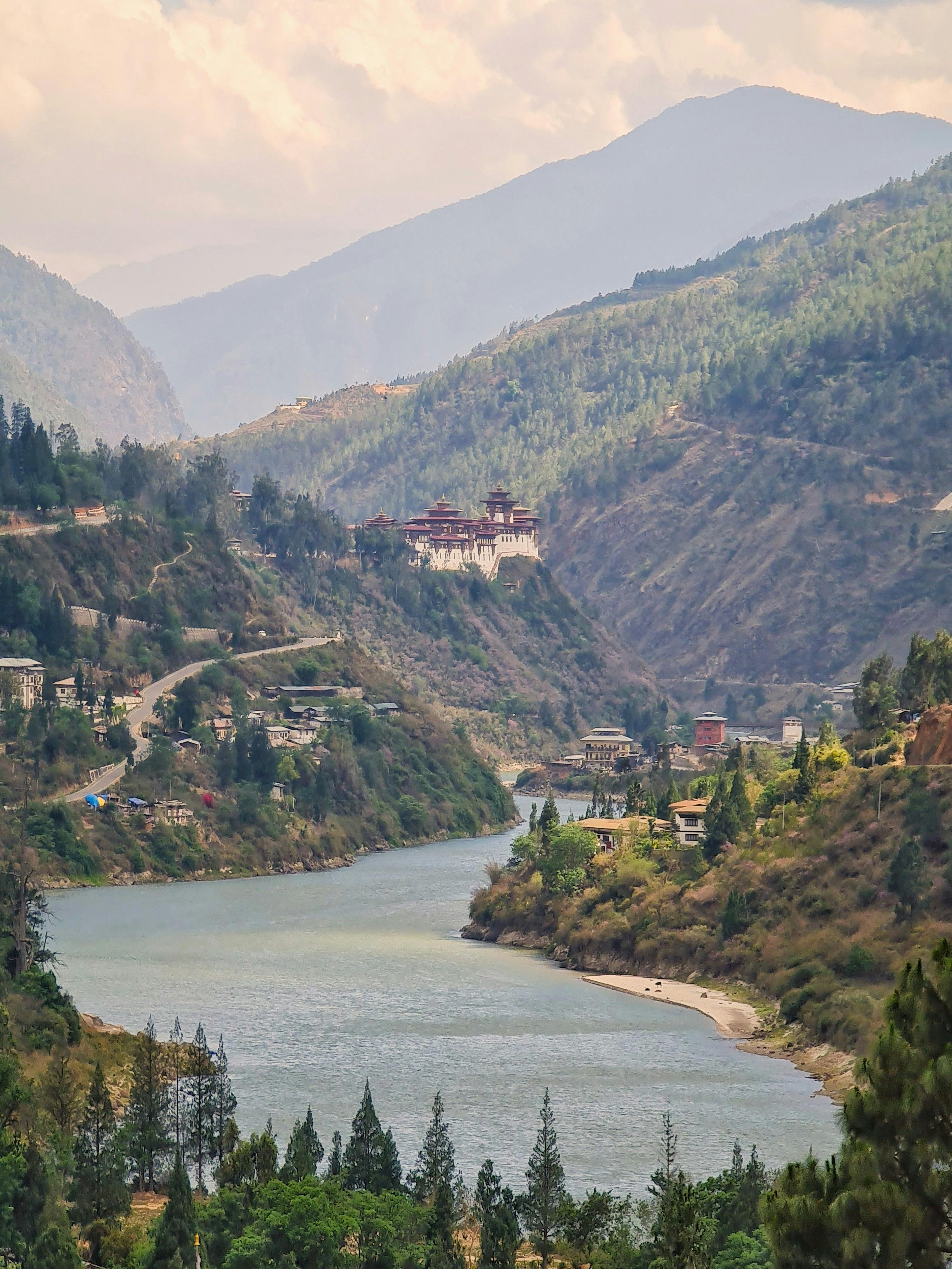 A stunning view of Wangdue Phodrang Monastery amidst the serene Bhutanese valley and river.